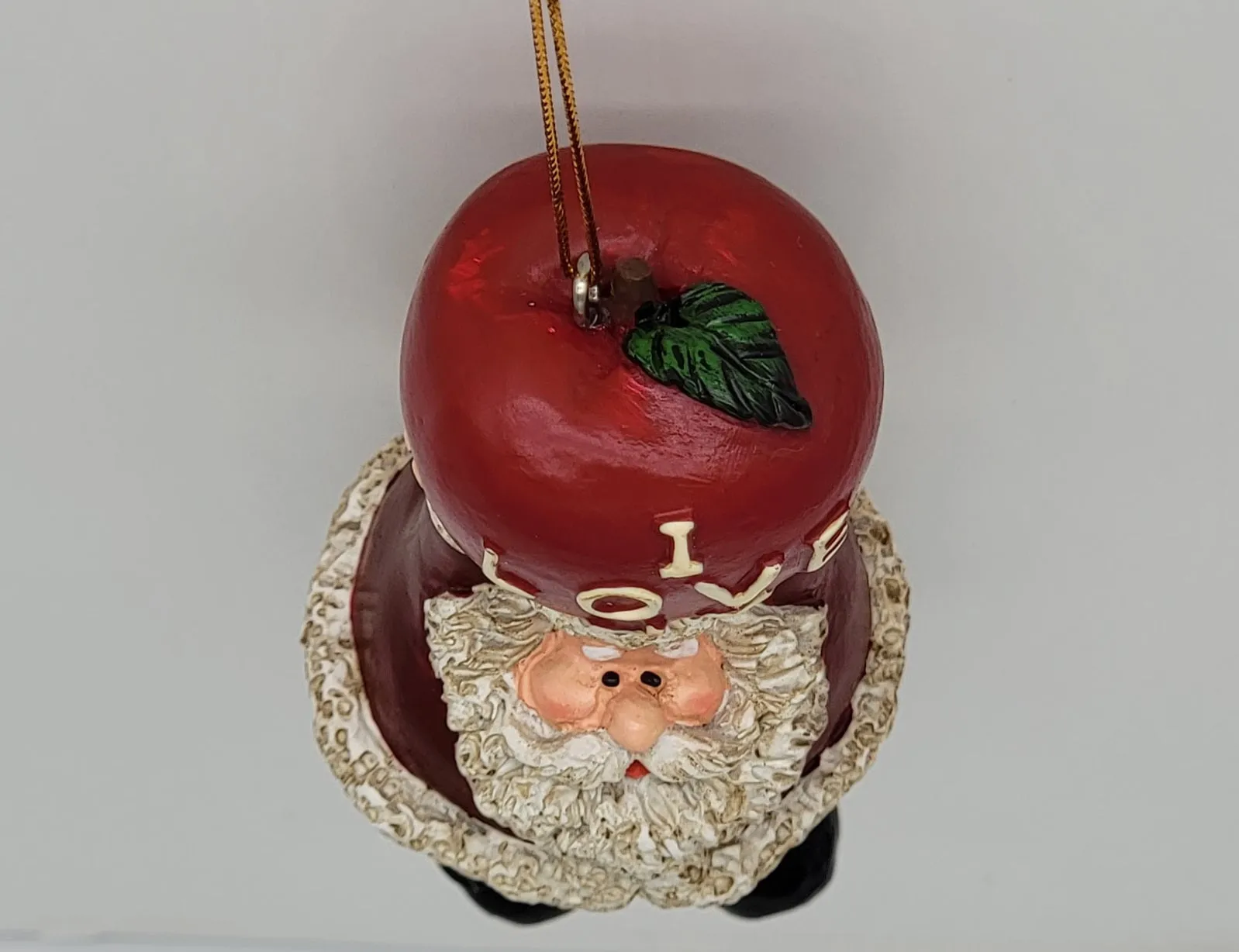 Santa Holding A Big Apple Christmas Ornament